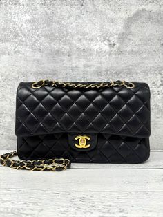 Designer: Chanel Model: Classic Double Flap  Condition: Good. Visible corner wear and scuffs. Minor creases and indentations on exterior. Faint hairline scratches on hardware. Minor scuffs and wear on the interior of bag. Measurements: 6 height x 10 width x 3 depth (inches) Exterior Material: Lambskin Exterior Color: Black Interior Material: Lambskin Interior Color: Burgundy Hardware Color: Gold Origins: Made in France 24 series Flap Shoulder Bag, Chanel Model, Bag Measurements, Chanel Black, Interior Color, Black Interior, New Bag, Colorful Interiors, Made In France