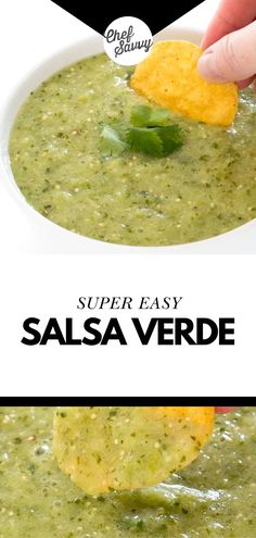 a hand dipping a tortilla chip into a bowl of salsa verde