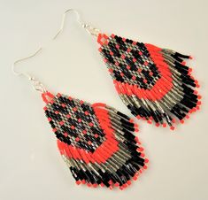 Welcome to Kartika Earrings Australia. You are buying, 1 Pair of Miyuki Handmade Beaded Dangle Fashion Earrings. BEADED PATTERN SIZE - 70mm Long X 35mm Wide OVERALL EARRING LENGTH - 80mm Long COLOURS - Red Grey and Black Colours SILVER COLOUR HOOKS - LEAD FREE, NICKEL FREE, CADMIUM FREE ALL OUR EARRINGS ARE HANDMADE IN AUSTRALIA We post every morning and afternoon. Please allow 3 - 10 days postage time within Australia. Please allow 10 - 28 days postage Worldwide. Thank you Regards Kartika Earri Red Teardrop Beaded Earrings For Festival, Red Bohemian Beaded Earrings, Red Black And White Beaded Earrings, Red And Black Beaded Earrings For Festival, Red And Black Beaded Festival Earrings, Red Sterling Silver Nickel-free Beaded Earrings, Red Bohemian Nickel-free Chandelier Earrings, Dangle Earrings Silver, Motifs Perler