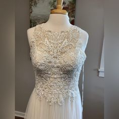 a white wedding dress on a mannequin