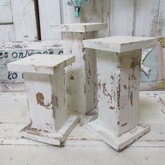 two white wooden pedestals sitting next to each other