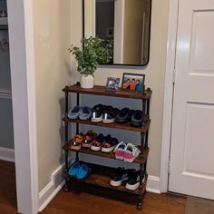 there is a shoe rack with many pairs of shoes on it