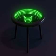 a round table with green lights on it's sides and a black base, in the dark