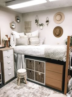 a bedroom with a bed, dressers and hats on the wall