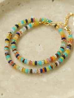 Experience the vibrancy and elegance of our Colorful Stone Beaded Necklace, a stunning accessory crafted with 18K gold plating and natural stones. Versatile in size and weighting just 14.5g, this necklace adds a touch of color and quality to any outfit. Elevate your style with this playful yet refined piece. Metal: 18K Recycled Gold Plated On Brass Gemstone: Natural stone Necklace Length: 380-470mm Weight: 14.5g Gold Rondelle Beaded Necklace With Natural Stones, Gold Rondelle Bohemian Jewelry, Yellow Gold Beaded Necklaces With Colorful Beads, Bohemian Gold Rondelle Jewelry, Gold Beaded Necklaces With Natural Stones And Czech Glass, Handmade Multicolor Gold-plated Jewelry, Yellow Gold Beaded Necklaces With Natural Stones, Elegant Gemstone Beads In Gold, Gold Jewelry With Natural Oval Beads