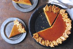 two plates with slices of pumpkin pie on them