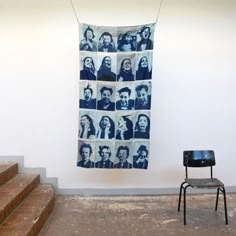 a chair sitting in front of a wall with pictures hanging from it's sides