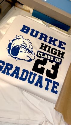 a white t - shirt with blue and black letters that read duke high class of graduate