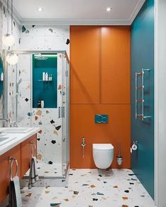 a bathroom with an orange and blue wall