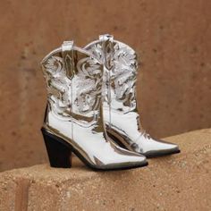 Billini Sergio Silver Chrome Pointed-Toe Western Boots Color.Silver Size: 9 Man-Made Upper, Man-Made Lining, Man-Made Sole. Imported. 3" Stacked Angled Heel. Lightly Cushioned Insole. Rubber Sole Has Nonskid Markings No Box Silver High Heel Western Boots, Silver Round Toe Boots For Spring, Silver Ankle Boots For Fall, Trendy Silver Summer Boots, Silver Shiny Boots For Party, Trendy Silver Boots For Fall, Silver Snip Toe Boots For Formal Occasions, Elegant Silver Boots With Round Toe, Glamorous Metallic Silver Boots With Pointed Toe