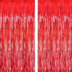 two red curtains with fringes on them