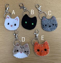 four different key chains with cats on them