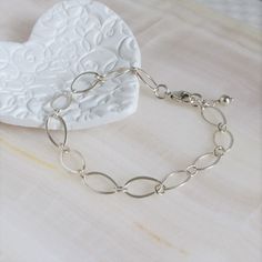 "* Sterling Silver Long Loop Layering Bracelet * * Beautiful sterling silver long loop layering bracelet finished with a sterling silver lobster claw clasp and completed with sterling silver bead. This bracelet 7\" long and is created with 925 sterling silver material and not made with plated materials. * Heart Clay Dish (also sold separately) https://www.etsy.com/listing/1094093610/heart-ring-dish-boho-ring-dish-christmas * This bracelet will arrive in a box tied with a ribbon perfect for gift Simple Handmade Silver Bracelets, Simple Handmade Silver Bracelet, Adjustable Oval Link Sterling Silver Bracelet As Gift, Nickel-free Link Chain Bracelet Minimalist Style, Dainty Handmade Silver Chain Bracelet, Minimalist Oval Chain Bracelet Gift, Elegant Handmade Sterling Silver Bracelet For Everyday, Elegant Hypoallergenic Sterling Silver Chain Bracelet, Adjustable Sterling Silver Charm Bracelet Modern Style