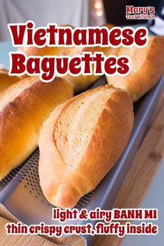 two loaves of bread sitting on top of a metal grater with the words vietnamese baguettes