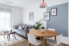 a living room with a couch, table and chairs