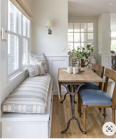 a dining room table with two chairs and a bench