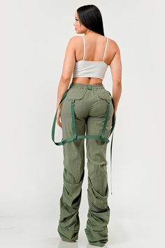 This distinct fashion choice merges the practicality of traditional utility wear with a touch of contemporary finesse. The pants are an ode to the functional attributes of cargo garments, designed to be robust with ample pocket space for practical use. The ruched detailing along the legs introduces a unique aesthetic twist, creating a gathered, textured effect that adds visual interest and a flair of modern sophistication. The inclusion of sleek, tonal belt straps further accentuates the waistli Utility Wear, Utility Cargo Pants, Robust Design, Mens Accessories Fashion, Unique Aesthetic, Sweater Jacket, Set Dress, Cargo Pants, Made In China