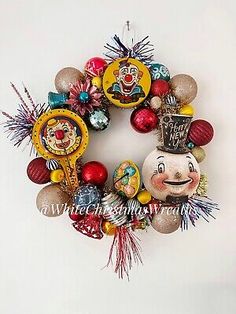 a christmas ornament hanging on the side of a wall with ornaments around it