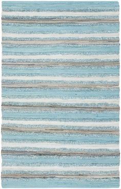 a blue and white rug with stripes on the bottom, in different shades of gray