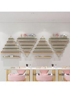 a dining room with pink chairs and gold shelving