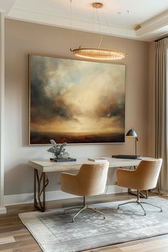 a painting hanging on the wall next to two chairs in front of a table with a lamp