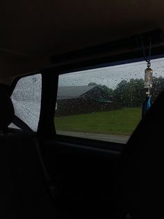 the rain is pouring down on cars windshields as they drive through an open field