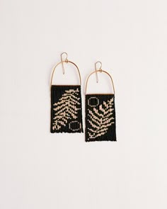 black and gold beaded earrings on white background