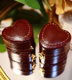 two wooden heart shaped boxes sitting on top of a table