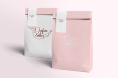 two pink and white paper bags with the same design on each bag, one is for cakes