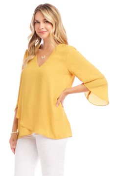 An elegant top of silky, lightweight crepe delivers elegant movement with its angled flare sleeves and fluttery asymmetrical hemline that dips low in back. 25 1/2" length (size Medium) V-neck Three-quarter sleeves Back yoke with gathering Crossover high/low hem 100% polyester Dry clean or hand wash, line dry Made in the USA of imported fabric Women's Clothing Elegant Stretch Top With Asymmetrical Hem, Elegant Stretch Tops With Asymmetrical Hem, Chic Flowy Rayon Blouse, Elegant Asymmetrical Solid Blouse, Elegant Spring Crepe Tops, Elegant Stretch Tops With Flutter Sleeves, Spring Blouse With Asymmetrical Hem And Stretch, Spring Stretch Blouse With Asymmetrical Hem, Elegant Summer Tops With Draped Sleeves