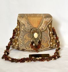 Vintage Mary Frances handbag as beautiful as the day it was purchased but never worn. Fabric tones are soft gold tones and olive green with pearl like decorations adorning the sides with additional topaz tone beading, etc. Measurements are 6 1/2" high from center top to base, 8" across the horizontal bottom, strap measured from top center to side 11" per side approx. width of strap measures 1". Made in the Philipines, additional pat. slip on inner lining. Please email with questions, Free shipping. Designer Gold Embellished Shoulder Bag, Gold Clutch Shoulder Bag For Fashion Accessory, Rectangular Gold Evening Bag, Designer Gold Shoulder Bag For Formal Occasions, Vintage Gold Shoulder Bag For Party, Formal Embellished Shoulder Bag, Gold Embellished Evening Shoulder Bag, Formal Beaded Shoulder Bag, Elegant Gold Shoulder Bag