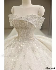 a white wedding dress with sequins on it