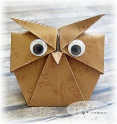 an origami owl made out of brown paper