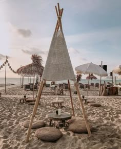 an umbrella and some chairs on the beach