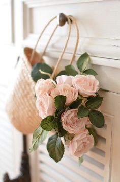 a pink purse with flowers hanging from it