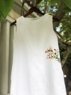 ❤ The white linen hand embroidered dress is very soft, skin friendly, breezy and comfortable.  ❤ Item description: - A lovely dress with embroidered wild flowers motifs. - Material: linen, button, embroidery threads. - Environmentally friendly. - This dress is very useful, go with any outfit, that can be used to go out, go shopping...    It is a perfect gift for yourself or your beloved.  ❤ Care instructions:      The best way to wash embroidery cloth is to put it in soapy water (with a mild detergent and cold water at 86 ºF/30oС) for 20 minutes. Try to not wash the item with other clothing that might cause damage, such as zippers, buttons or different colors. You wash it by hand, and if you have dirty patches on your garment, you can gently rub them, it's best not to rub directly against Spring White Embroidered Linen Dress, White Embroidered Linen Beach Dress, White Linen Dress For Summer Garden Party, White Linen Dress With Floral Embroidery For Summer, White Linen Floral Print Dress, White Linen Dress With Floral Print, White Embroidered A-line Summer Dress, White Embroidered A-line Dress For Summer, White A-line Embroidered Summer Dress