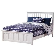 a white bed with blue and white comforter on it's headboard, in front of a white background