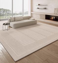 a living room with a couch, fireplace and large rug on the floor in front of it