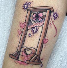 a tattoo with an image of a clock and hearts on the side of her leg