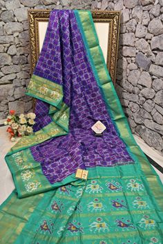 A broad border along with the ikat tye and dye work all over the pallu with an illuminating zari work on the pallu and border in traditional style makes it complementary to each other along with a solid purple and rama green color body. Color: A shade of Purple and rama green color Technique: Amazing work of ikat weaving work on the whole saree with solid body Fabric: Ikat Silk Quality: Indyvogue's Assurance of Pure Silk Mark Certified Saree Ikat Weaving, Tye And Dye, How To Wash Silk, Ikat Saree, Blouse Measurement, Color Techniques, Zari Work, Silk Sarees Online, Body Color