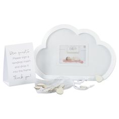 a white cloud shaped plate next to a thank card and some baby's name tags