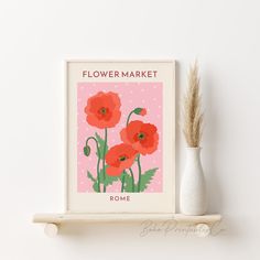 a flower market poster on a shelf next to a vase with a plant in it