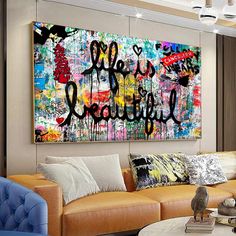 a living room filled with furniture and a large painting on the wall above it's couches