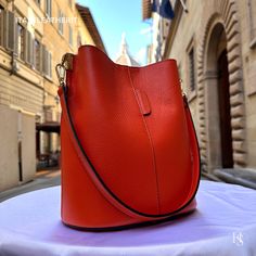 "This bag has been made of the best genuine leather by local master crafters of Florence in Italy, designed for women who only accept premium Italian quality and luxury leather bags and modern Italian fashion. . Size: Width: 27 cm / 10.75 inches Height: 19 cm / 7.50 inches Depth: 9 cm / 3.50 inches . The story of this bag : Once upon a time, in the charming city of Florence, Italy, renowned for its exquisite artistry and craftsmanship, there existed a small workshop tucked away in a cobblestone alley. This was the home of a gifted artisan named Alessio, whose passion for creating beauty out of leather was unparalleled. Alessio specialized in handcrafted leather goods, and his most prized creations were the leather clutch bags that exuded elegance and sophistication. The timeless charm of h High-end Leather Bucket Bag, High-end Everyday Pouch Bucket Bag, High-end Bags With Leather Lining For Daily Use, High-end Leather Bucket Bag For Travel, Luxury Bucket Shape Office Bag, Elegant Bucket Shape Shoulder Bag With Leather Lining, Elegant Leather-lined Bucket Shoulder Bag, Luxury Calf Leather Bucket Shoulder Bag, Formal Calf Leather Bucket Shoulder Bag