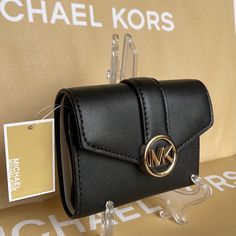 Michael Kors Carmen Medium Logo And Faux Leather Wallet Black All Our Listed Item Are Authentic, Brand New Condition With Tag Size: Approximately 4.89 Wide X 3.67 Long X 1.63 Thick (Inch) Weight: Approximately 120 G Material: Leather Opening And Closing Type: Snap Internal Style: Zipper Coin Purse X 1, Wallet X 1, Open Pocket X 2, Card Pocket X 6 External Style: 1 Open Pocket 35s2gnmf6l Leather Travel Wallet With Logo, Elegant Everyday Wallets With Logo, Elegant Wallets With Logo, Michael Kors Black Wallet For Everyday Use, Elegant Travel Wallet With Logo, Michael Kors Travel Wallets With Gold-tone Hardware, Michael Kors Black Everyday Wallets, Chic Michael Kors Wallets For Everyday Use, Compact Black Bag With Card Slots