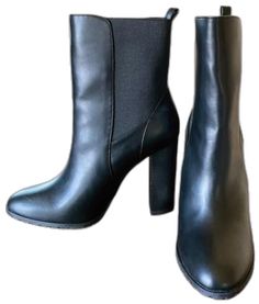 Black Faux Leather Heeled Boots For Office, Black Faux Leather Mid-calf Boots With Reinforced Heel, Medium Width Faux Leather Mid-calf Boots For Workwear, Black Faux Leather Mid-calf Boots For Office, Black Faux Leather Mid-calf Boots With Block Heel, Black High Ankle Mid-calf Boots For Office, Black Mid-calf Boots With Stacked Heel For Office, Black Block Heel Mid-calf Boots In Faux Leather, Sleek Black Faux Leather Mid-calf Boots