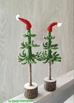 two crocheted christmas trees sitting on top of each other