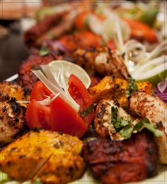 a plate full of grilled meat and vegetables