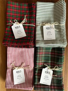 four different plaid napkins with tags on them