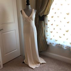 a wedding dress on display in front of a window